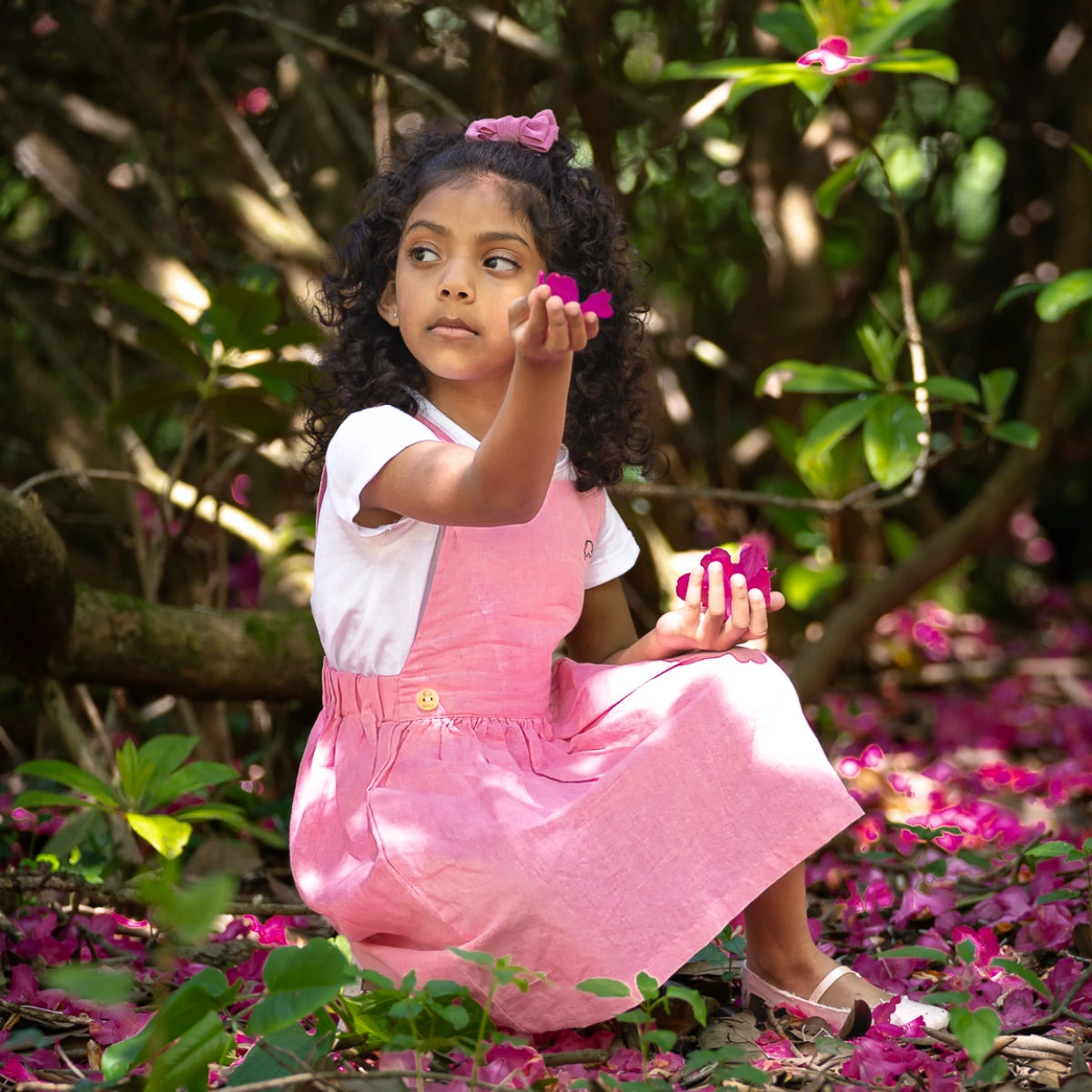 A girl in a pink dress.
