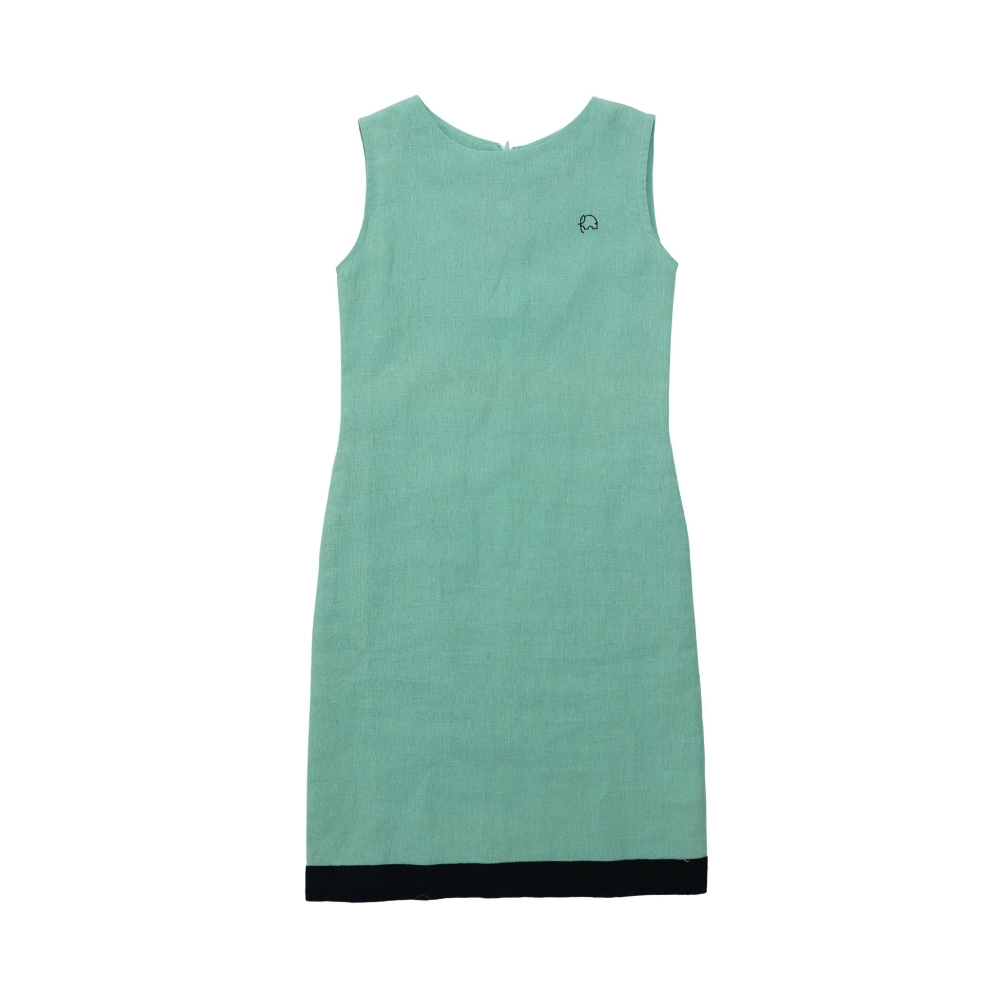 A sleeveless, Karee Neptune green shift dress with a black hemline, displayed against a white background.