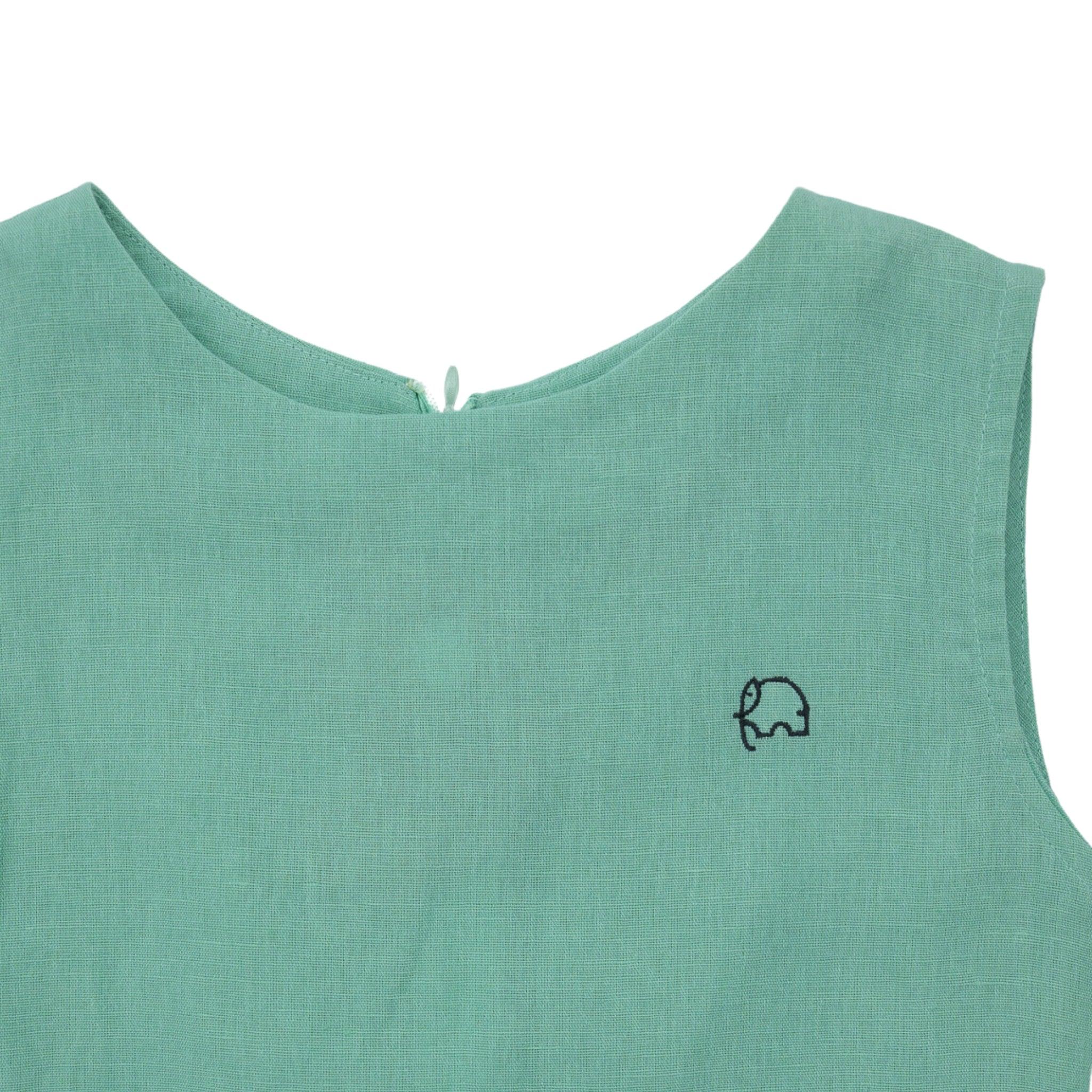Close-up of a Karee Neptune Green Linen Cotton Round Neck Frock for Kids with a small black elephant embroidery on the front.