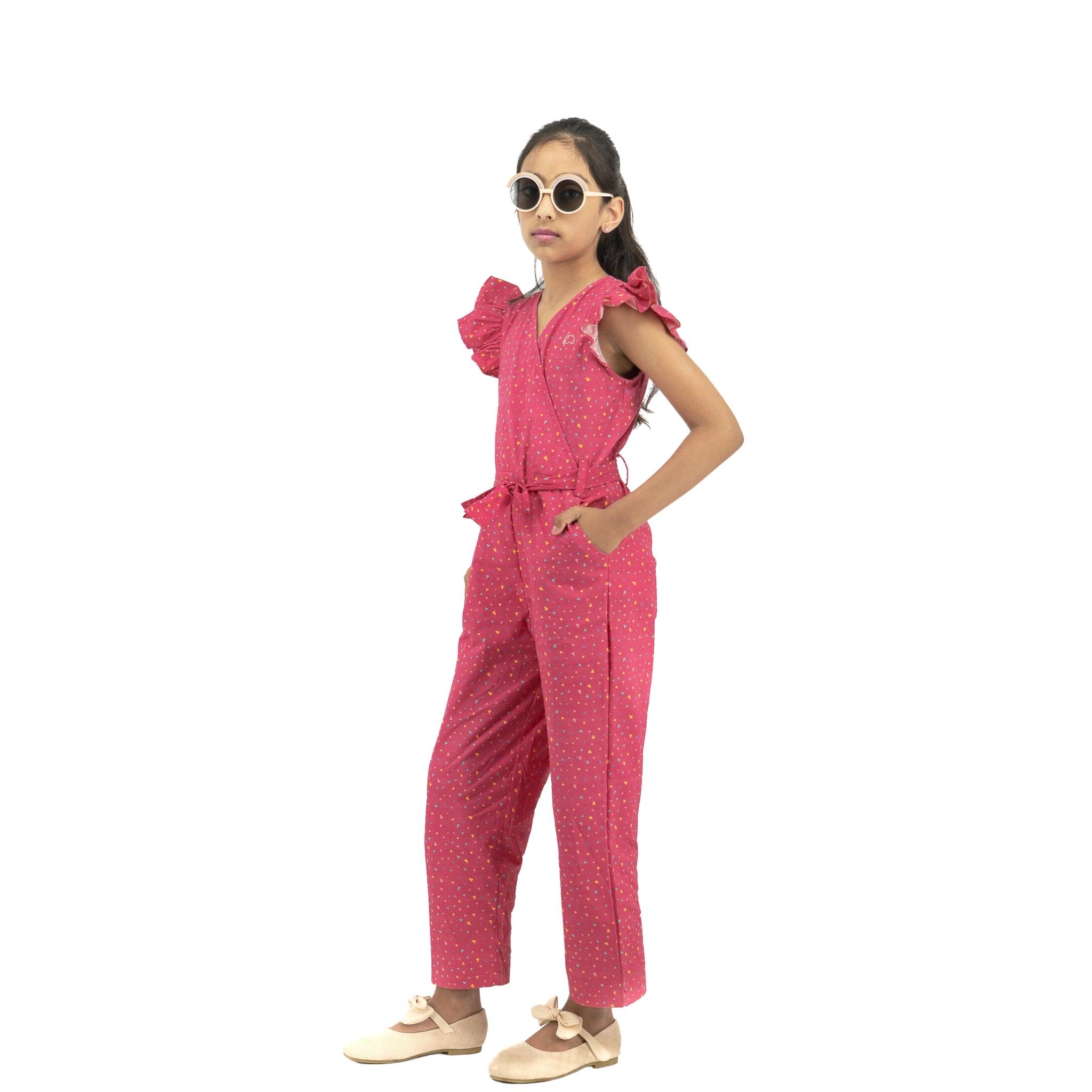 A young girl wearing a Karee Red Rose Cotton Jumpsuit and sunglasses, standing confidently with hands on hips, against a white background.