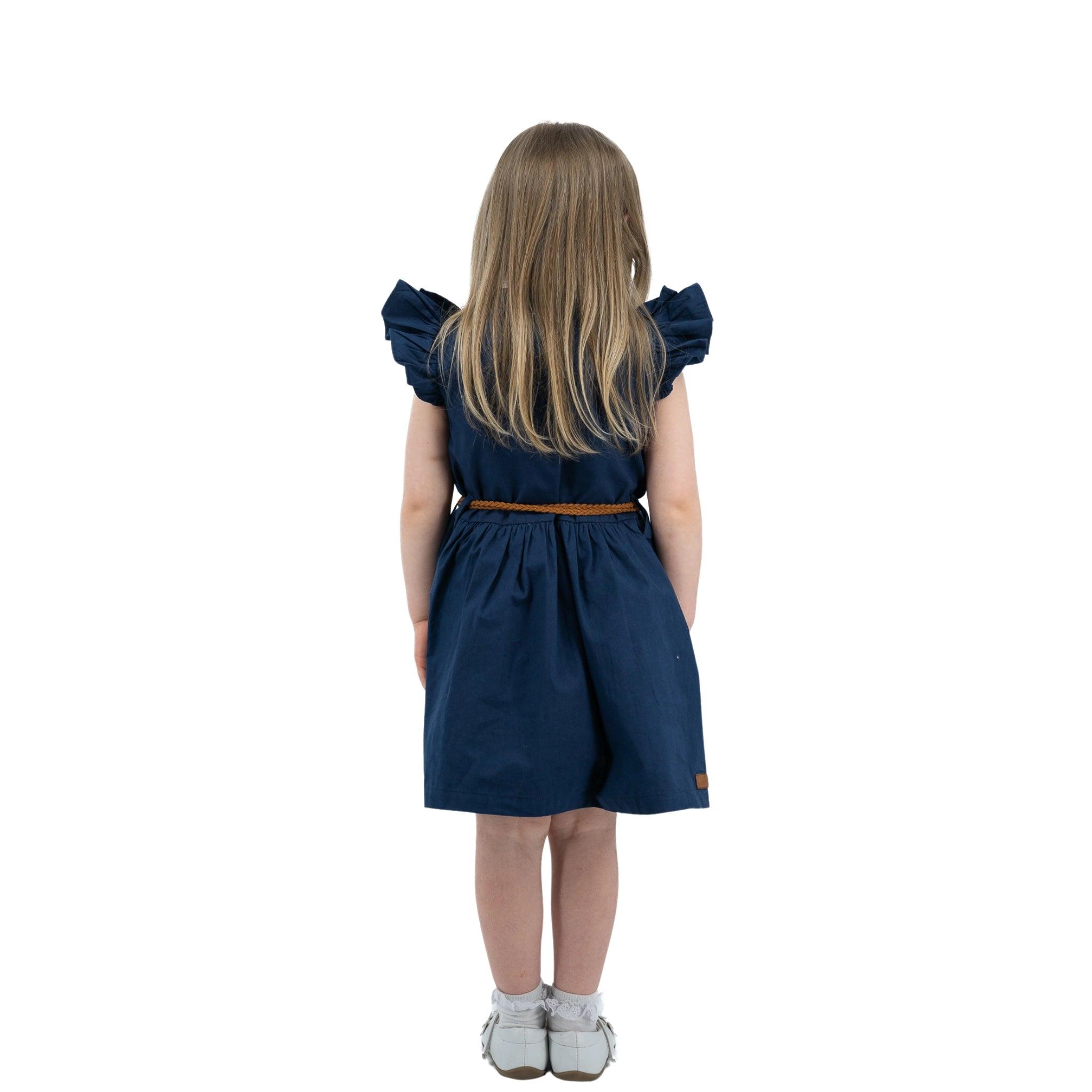 Young girl in a Karee Navy Blue Butterfly Sleeve Cotton Dress with an orange belt, seen from the back, standing against a white background.