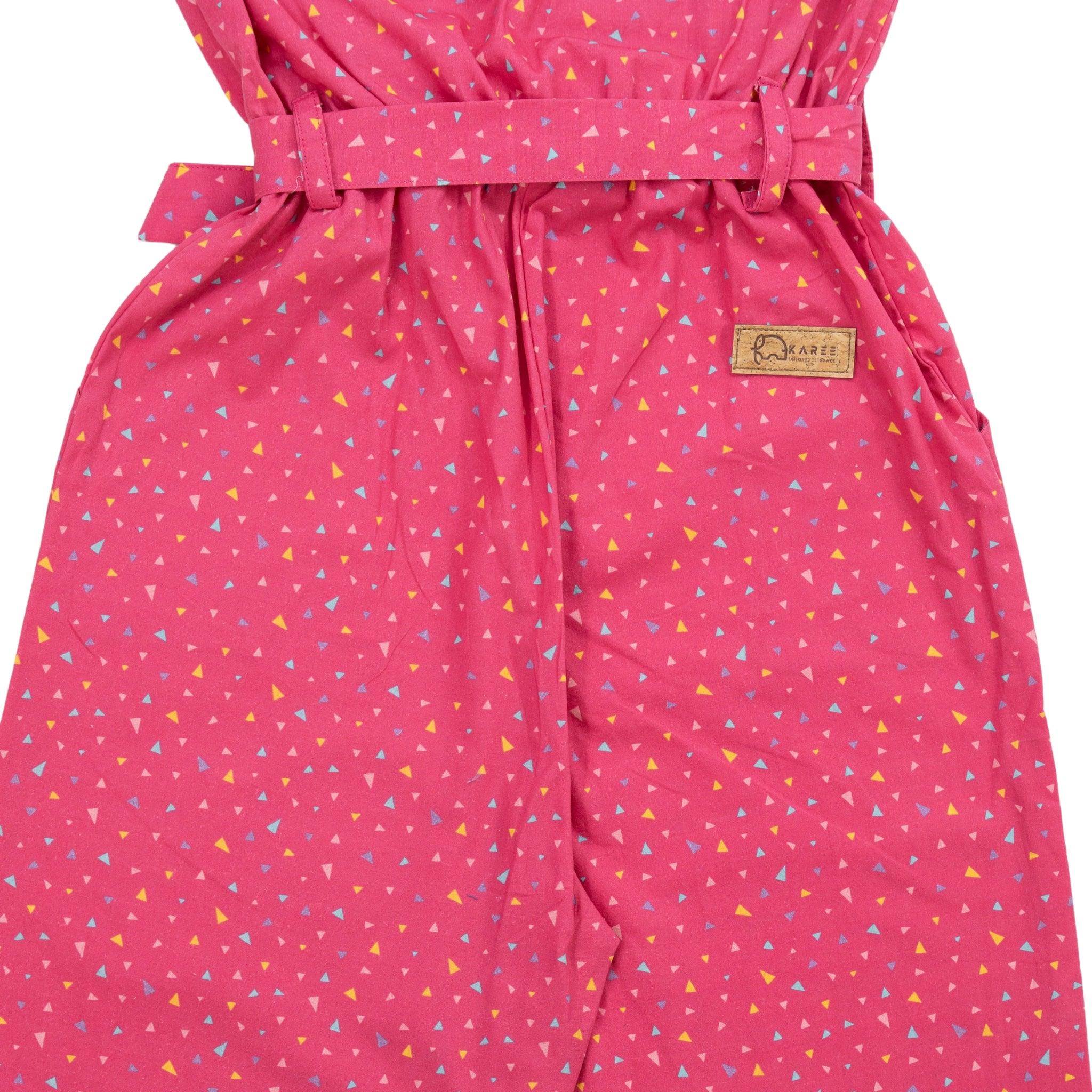 Close-up of a Red Rose cotton jumpsuit for girls with a triangle pattern, featuring a tied belt and a Karee label.
