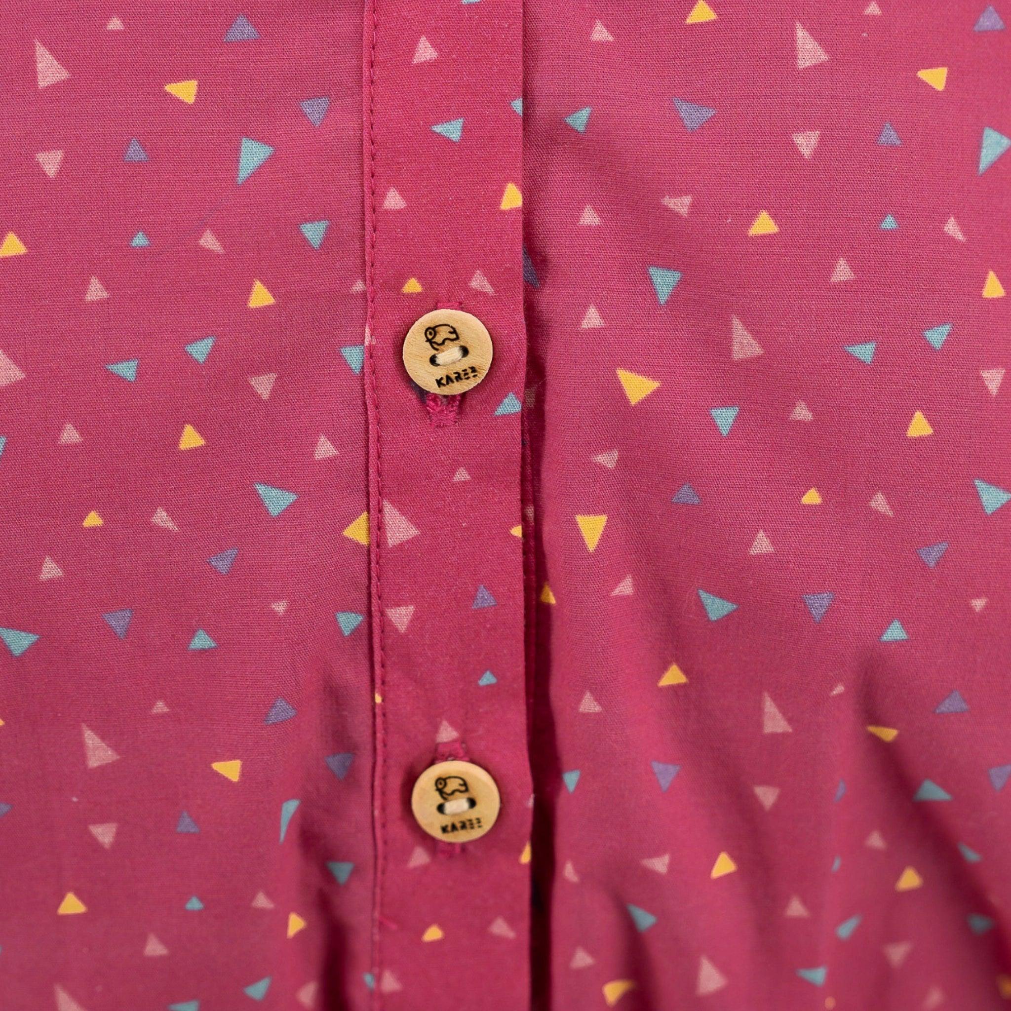 Close-up of a Red Rose Cotton Jumpsuit for Girls by Karee with a colorful triangle pattern and two wooden buttons on a placket.