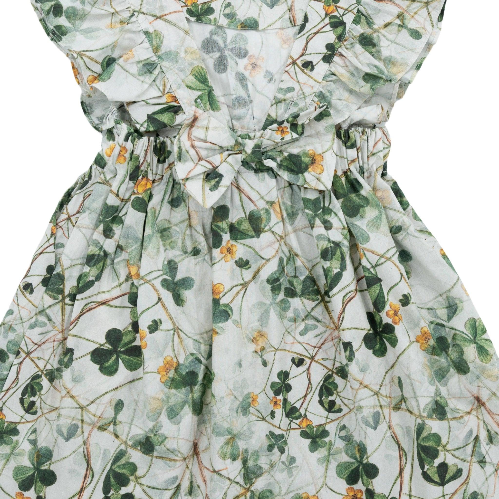 Close-up of a Karee green floral cotton dress for girls with a cinched waist and puff sleeves.