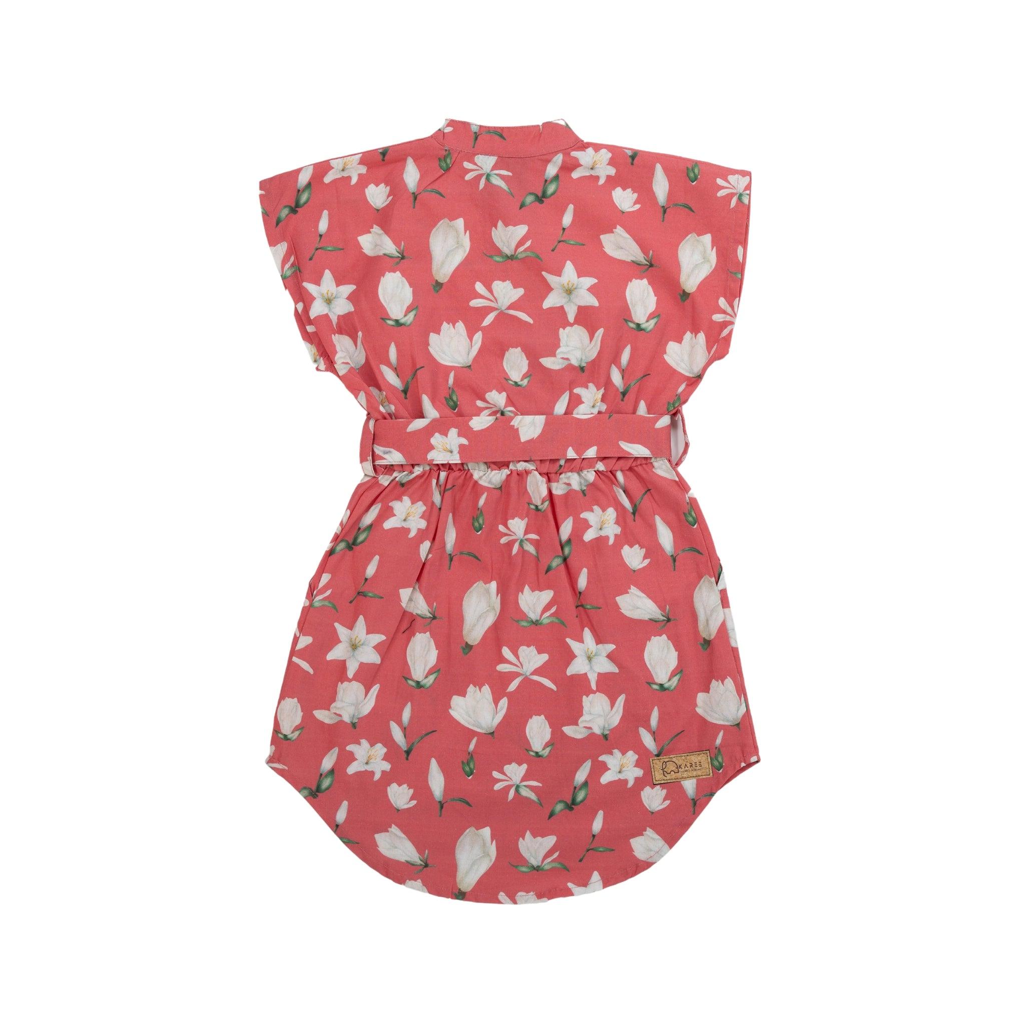 A sleeveless Mineral Red Lilly Blossom cotton shirt dress with a cinched waist, displayed against a white background by Karee.