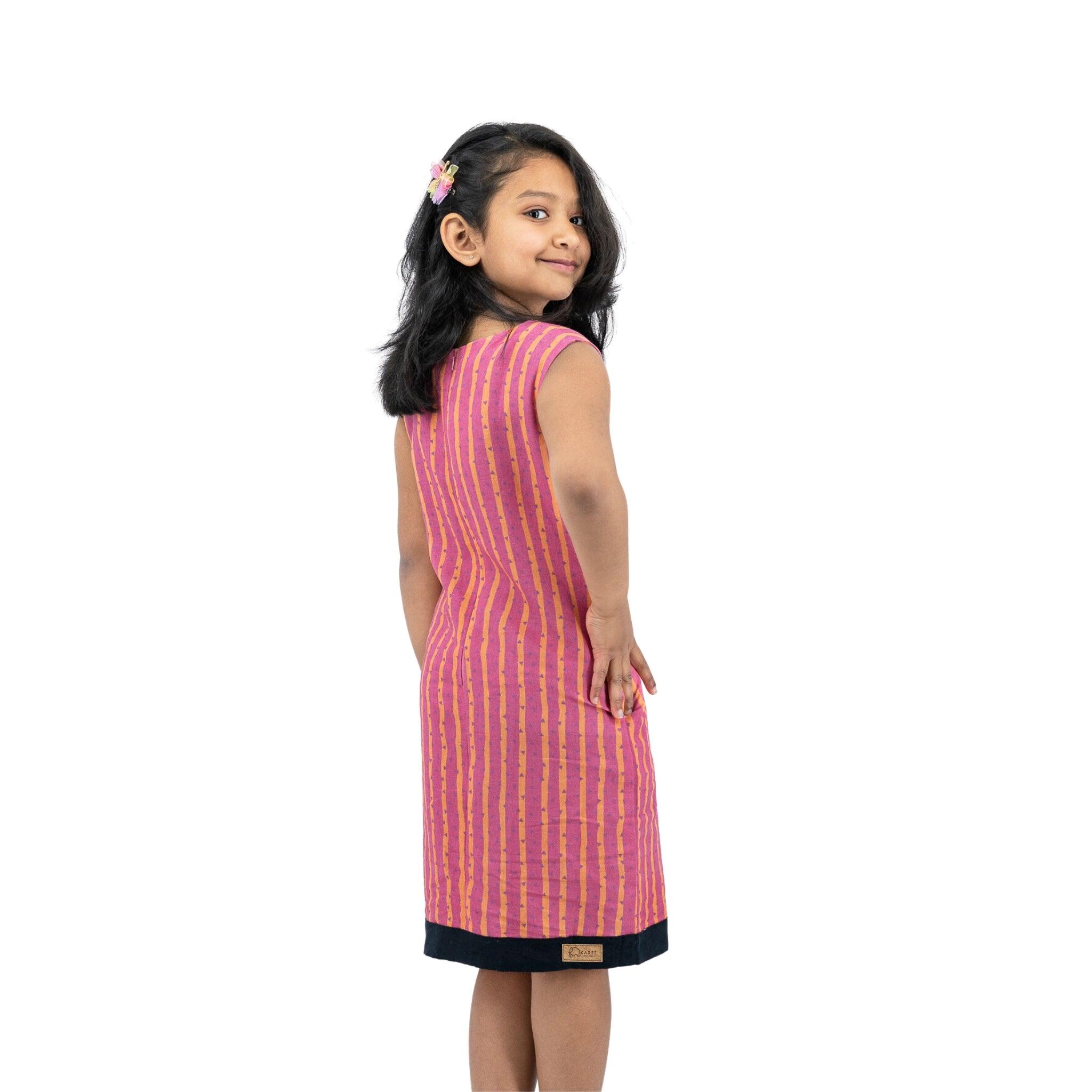 A girl in a Karee Lilac Rose Linen Cotton Round Neck Frock for Kids.