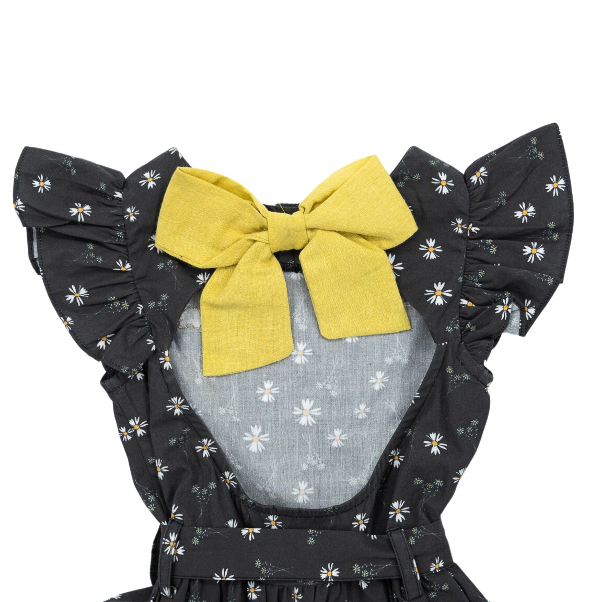 Karee Petite Blossom Black Cotton Dress with a prominent yellow bow on the bodice, isolated on a white background.