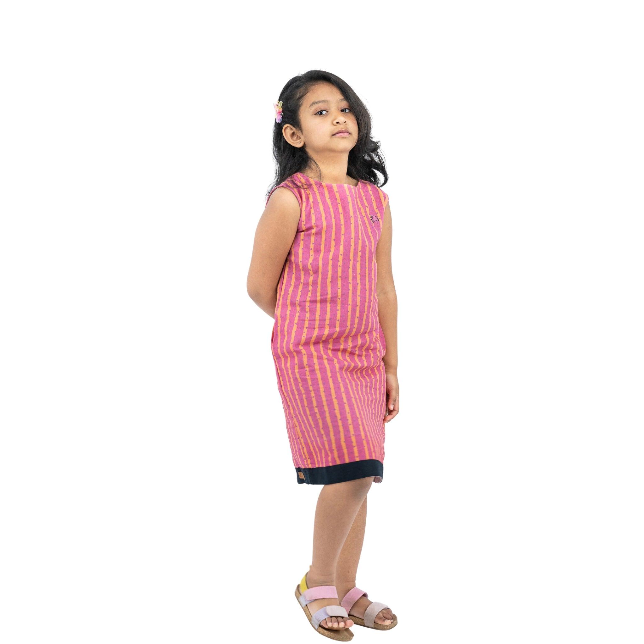 A girl in a Karee Linen Cotton Round Neck Frock for Kids in Lilac Rose.