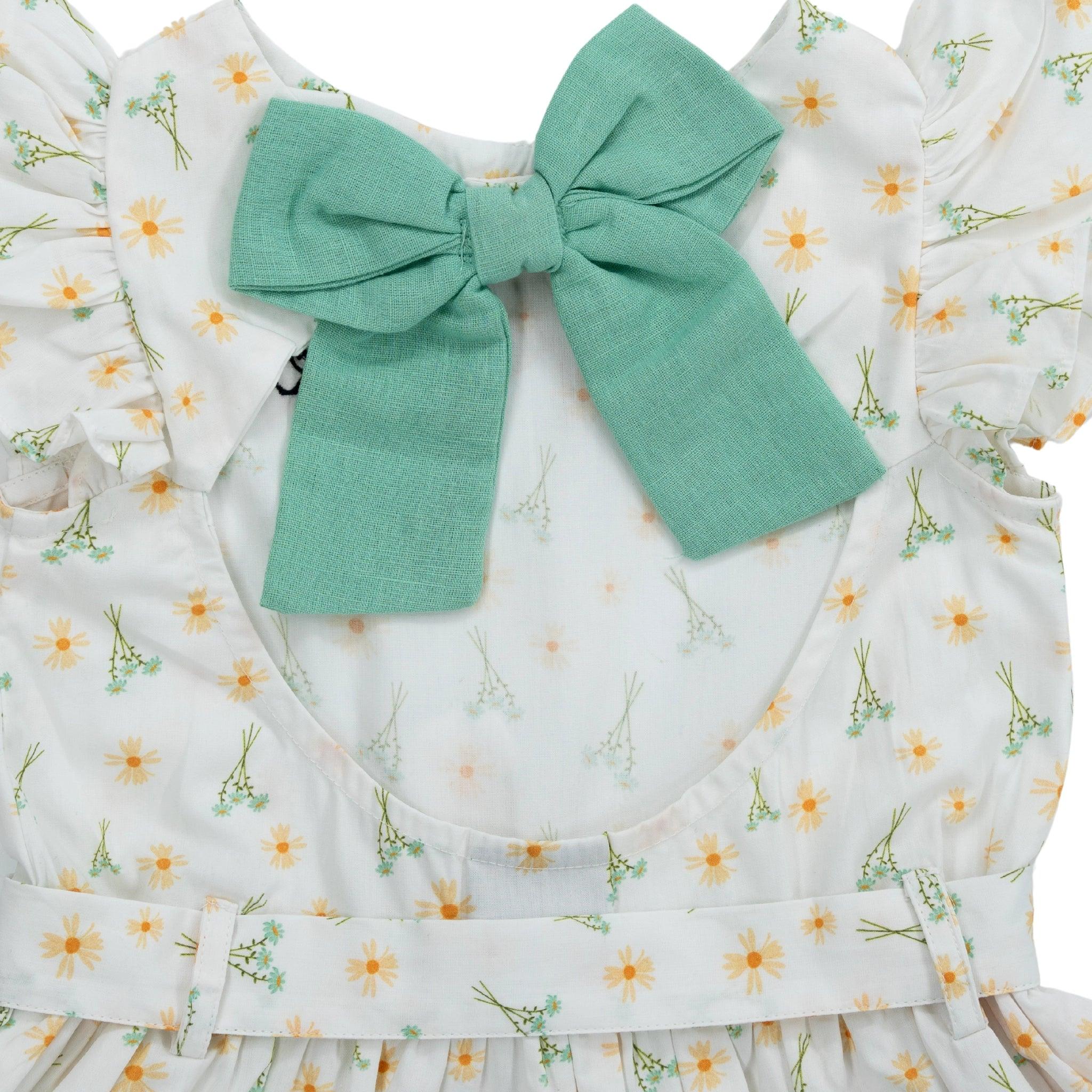 Close-up of a high-quality Karee Petite Blossom Cotton Dress in Smoked Pearl with a large teal bow on the neckline.