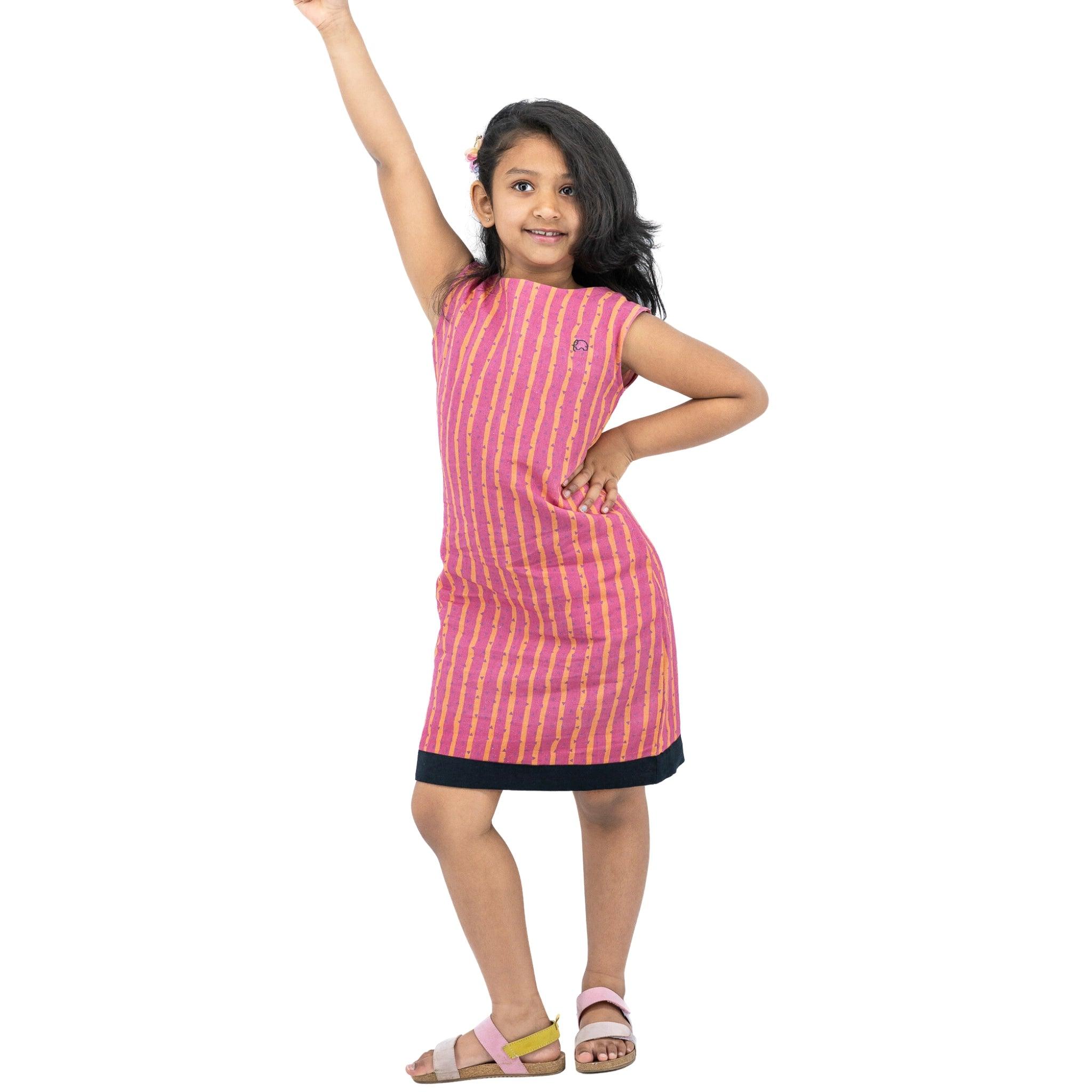 A girl in a Karee Linen Cotton Round Neck Frock for Kids in Lilac Rose with black stripes and her arm raised.