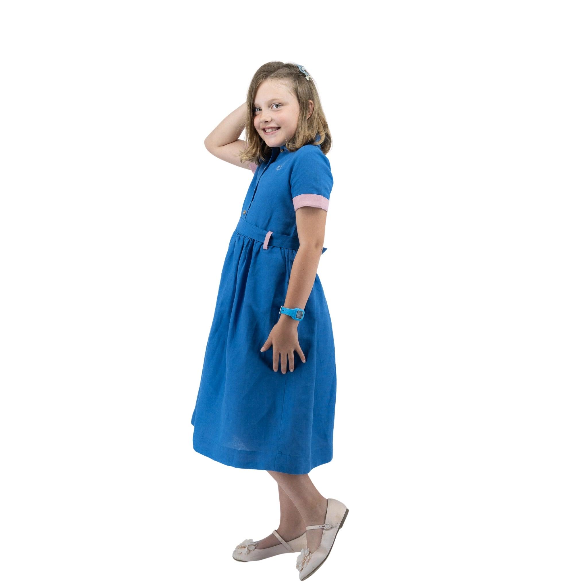 A girl in a Karee Parisian Blue Linen Dress for Girls.
