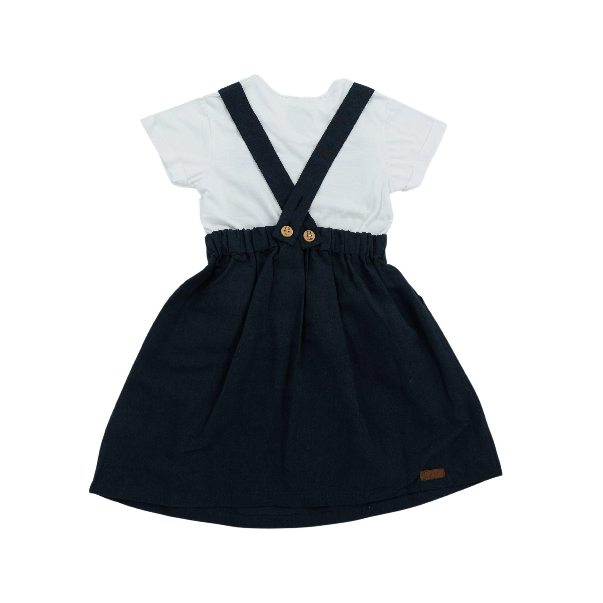 White t-shirt with a Karee Ebony Black Linen Pinafore for Girls, featuring button details, isolated on a white background.