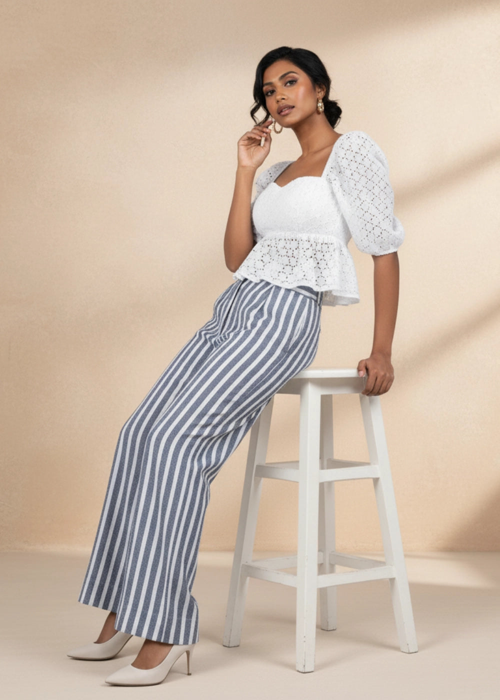 Model wearing Karee’s Monochrome Striped Linen Trousers — 100% natural linen wide-leg pants with high waist and pockets, sustainable women’s fashion.