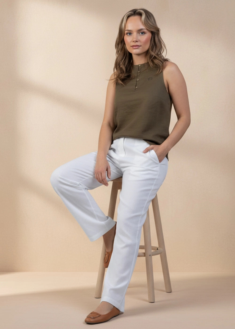 Model wearing Karee’s White Whisper Linen Trousers — sustainable white wide-leg linen pants with adjustable waist and pockets, ethically made in India.