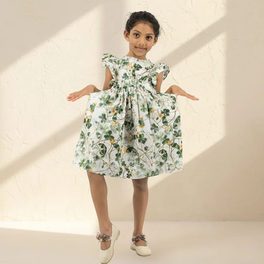 The Botanical Dress in Ivory clover, worn by a child
